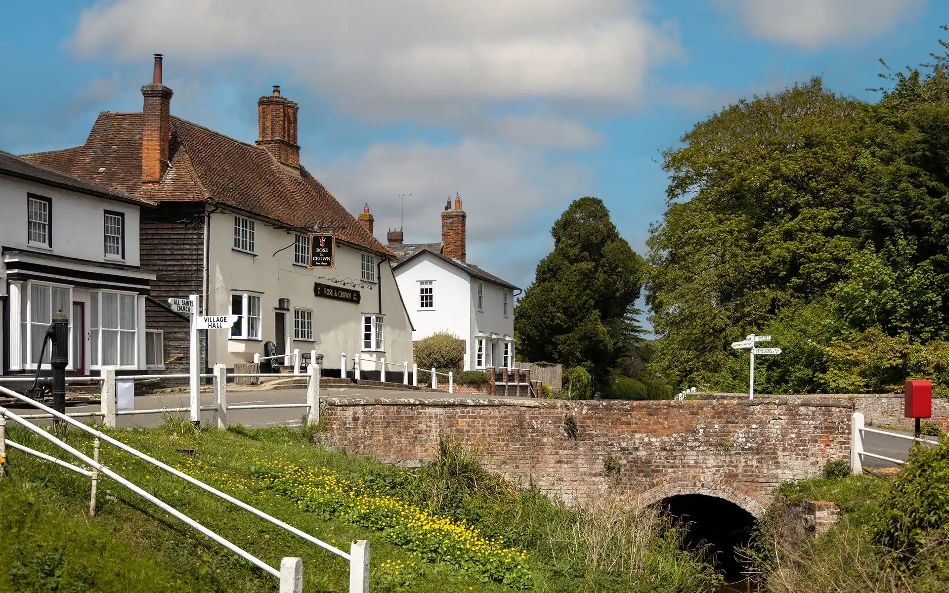The Rose & Crown Pub and Restaurant in Ashdon near Saffron Walden The Rose & Crown pub in Ashdon, near Saffron Walden, beside the village bridge on a sunny day