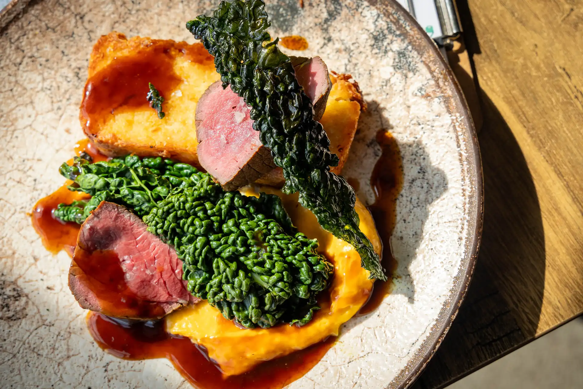 Treacle cured sirloin of Herefordshire beef Treacle cured sirloin of Herefordshire beef with potato and horseradish rosti, cavolo nero, squash and nutmeg purée and bone marrow jus